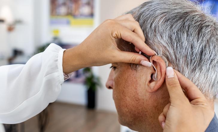 A man getting fitted for a hearing aid